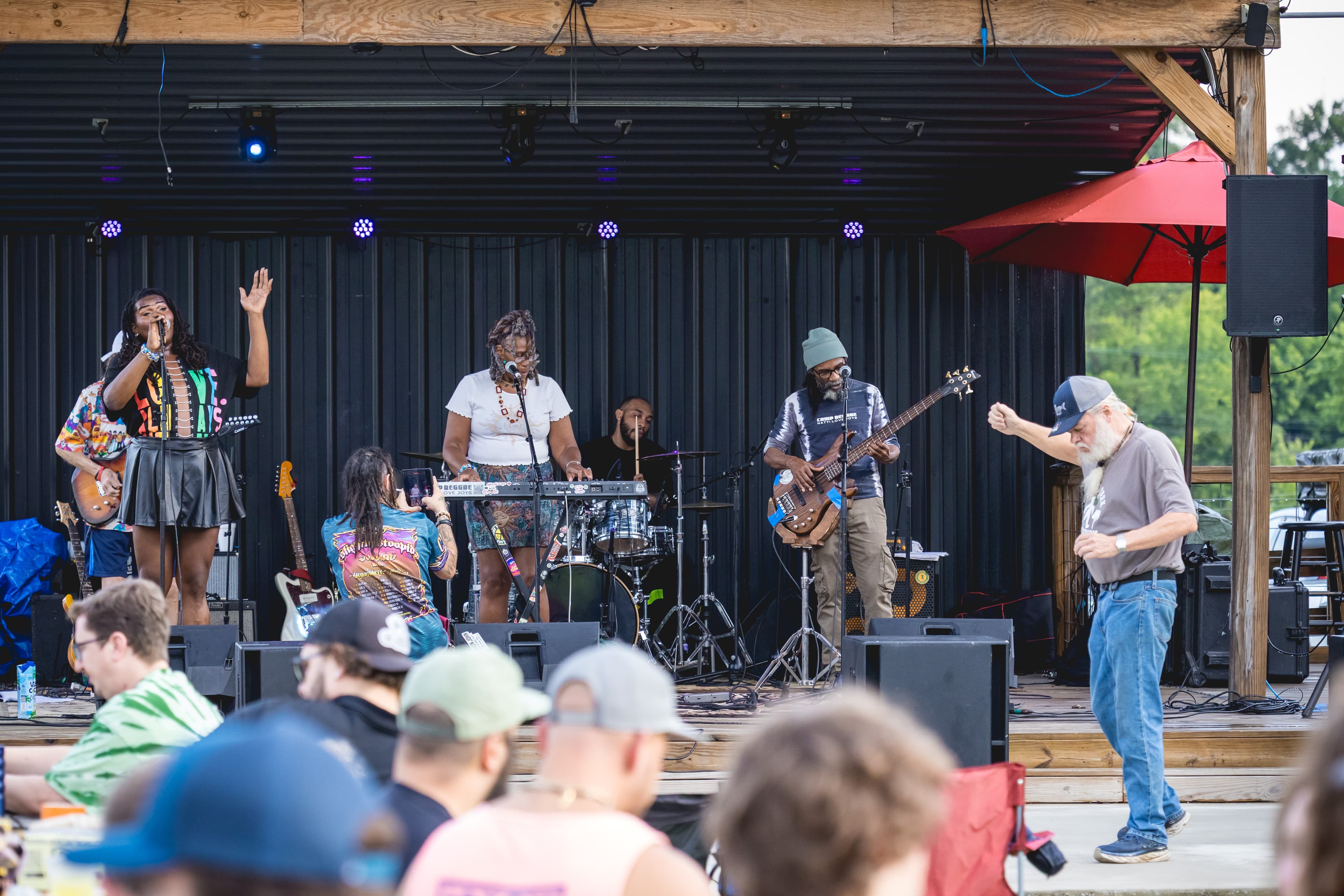 A band performing live on stage at Good Friends Music Fest